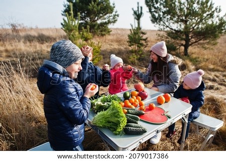 Similar – Image, Stock Photo Boy taking photo to family with apples in basket