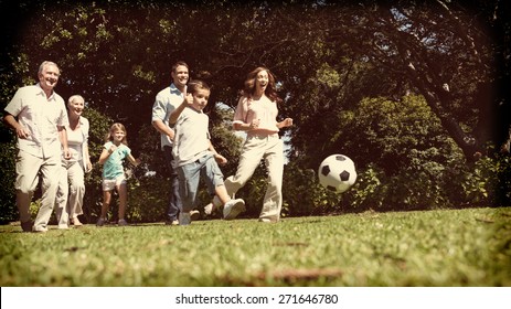 Cheerful multi generation family playing football in the park - Powered by Shutterstock