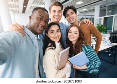 Cheerful Multicultural Students Posing Together Making Selfie In University Lecture Hall Indoors, Having Fun And Looking At Camera, Point Of View. College Friends, High School Education Concept