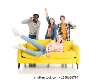  Cheerful Multiethnic Teenagers Showing Peace Gesture On Yellow Couch On White Background