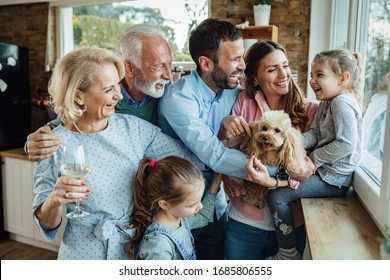 Cheerful multi-generation family with a dog having fun while spending time together at home. 