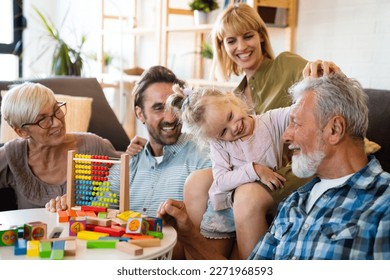 Cheerful multi-generation family having fun while spending time together at home. - Powered by Shutterstock