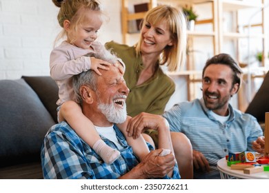 Cheerful multi-generation family having fun while spending time together at home. - Powered by Shutterstock