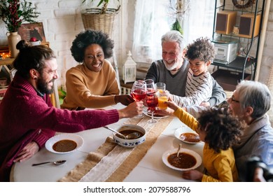 Cheerful multigeneration family spending good time together around kitchen table. - Powered by Shutterstock