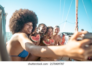 Cheerful Multiracial People Eating Watermelon While Girl With Curly Hair Taking A Selfie - Young Friends Having Fun On Boat During Their Holiday