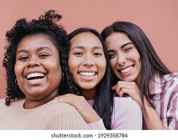 Cheerful multiracial women with different skin color looking in camera - Concept of friendship and happiness - Powered by Shutterstock