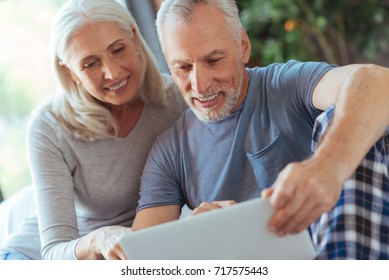 Cheerful nice aged couple using laptop - Powered by Shutterstock