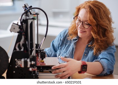 Cheerful nice designer using a 3d printer