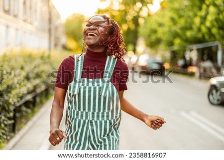 Similar – Image, Stock Photo Cheerful non-binary person dancing on the street in the city