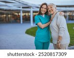 A cheerful nurse embraces an elderly woman in a park setting, showcasing care, support, and happiness. This image symbolizes healthcare, companionship, and the joy of community care.