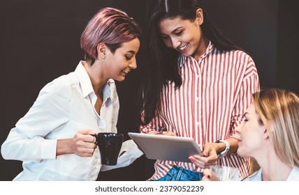 Cheerful office workers using tablet during break