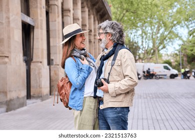 Cheerful old couple standing hugging and looking at each other love and affection outdoors in city. Retirees enjoying sightseeing on street in spring. Mature marriage relationship and retiree vacation - Powered by Shutterstock