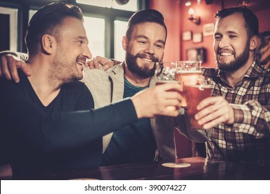 Cheerful Old Friends Having Fun And Drinking Draft Beer In Pub.