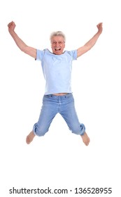 Cheerful Old Man Jumping On A White Background