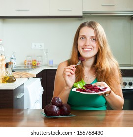 Cheerful Ordinary Girl Eating Boiled Beets At Home Interior