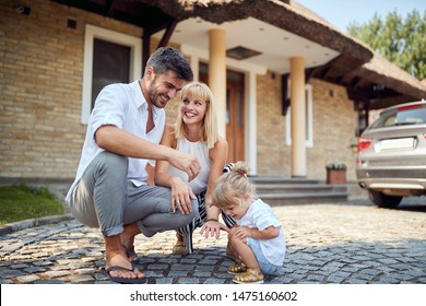 Cheerful parents with little child outdoor