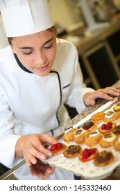 Cheerful Pastry Cook Holding Tray Of Pastries