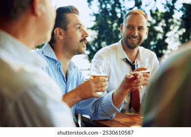 Cheerful people, businessmen, colleagues sitting at outdoor bar, restaurant, drinking beer, talking, discussing successful projects and partnership. Concept of business, meeting, fun, Oktoberfest - Powered by Shutterstock