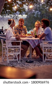 Cheerful People Having  At Party.Happy Friends Having Beer Party In Summer Evening. 