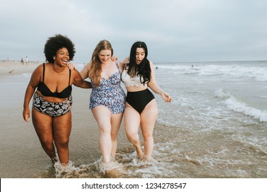 Cheerful plus size women enjoying the beach - Shutterstock ID 1234278547