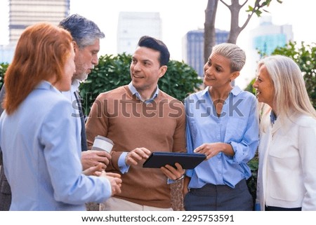 Cheerful Portrait of a happy group of co-workers laughing and having fun outdoors a corporate office area. High quality photo