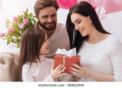 Cheerful Positive Girl Giving A Present