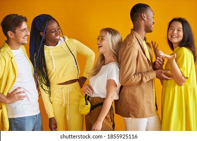 cheerful positive group of young people of diverse nationalities posing at camera togeher, wearing fashionable casual outfit, international friendship concept. people diversity