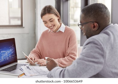 Cheerful Positive Intelligent Female Book Keeper And Male Financier Work With Modern Technologies And Documentation, Analyze Break In Market Or Budget Allocation, Collaborate For Common Purposes