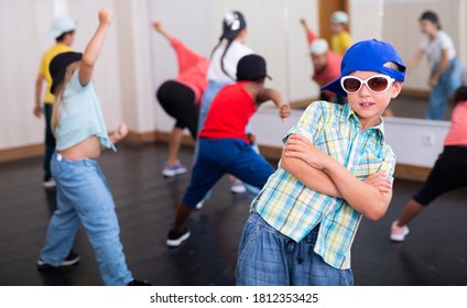 Cheerful Preteen Girls And Boys Hip Hop Dancers Doing Dance Workout With Female Trainer During Group Class