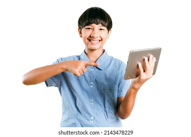 Cheerful Preteen Mix Race Boy Kid In A Uniform Point A Finger To A Tablet Computer Mobile For Online Learning, Social Media Chatting Or Play A Game On White Background. Child Technology Study Concept.