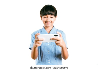 Cheerful Preteen Mix Race Boy Kid In A School Uniform Using A Smartphone For Online Learning, Social Media, App Texting, Or Playing An Online Game On White Background. Child Technology Study Concept.