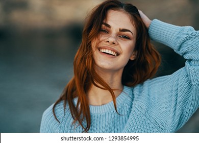 Cheerful pretty woman in blue sweater outdoors on nature - Shutterstock ID 1293854995
