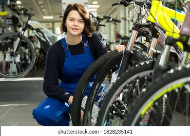 Cheerful Professional Woman Standing In Bicycle Shop