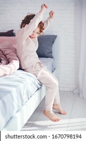 Cheerful Redhead Baby Boy Getting Up In The Morning At Sunny Bedroom