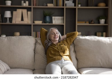 Cheerful Relaxed Mature Woman Resting On Comfortable Couch With Closed Eyes And Happy Smile, Stretching Body, Leaning On Back, Enjoying Comfort, Leisure Pause, Stress Relief, Meditating At Home