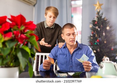 Cheerful Schoolboy Taking Money From His Positive Father Before Christmas Evening