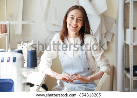 Similar – Image, Stock Photo Young female sitting by table and making clay or ceramic mug