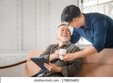 Cheerful Senior Asian Father And Middle Aged Son In Living Room, Happiness Asian Family Concepts