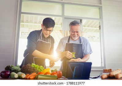 Cheerful Senior Asian Father And Middle Aged Son Cooking Together At Kitchen, Happiness Asian Family Concepts