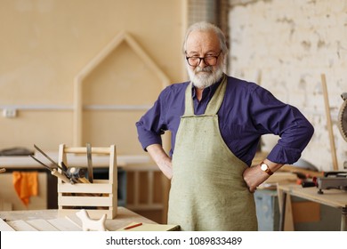 cheerful senior citizen is ready to work in the workshop. hardworking grandpa in the home workshop - Powered by Shutterstock