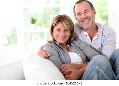 Cheerful senior couple enjoying being at home