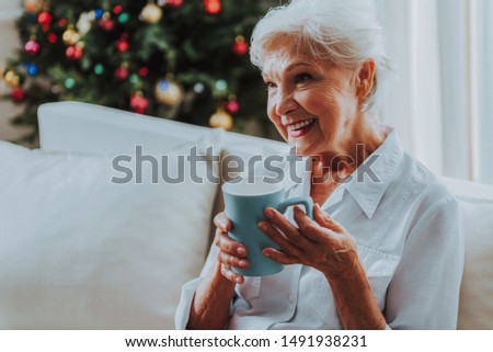Cheerful senior female drinking coffee stock photo
