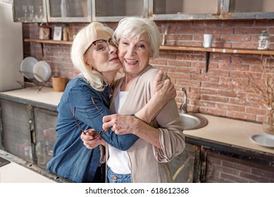 Cheerful Senior Ladies Embracing And Laughing