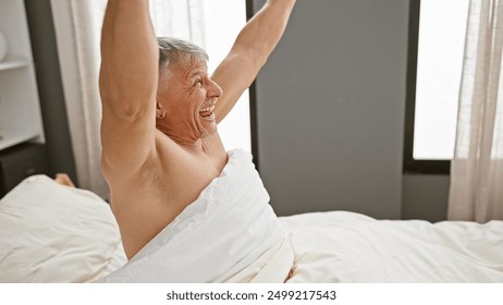 A cheerful senior man waking up stretching in a cozy bedroom scene at home. - Powered by Shutterstock