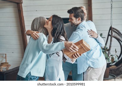 Cheerful Senior Parents Meeting Young Couple Inside The House