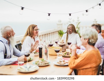 Cheerful Senior People Have Dinner Together Oudoor On Patio - Elderly Multiracial Friends