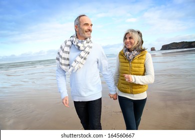 Cheerful Senior People Walking On The Beach