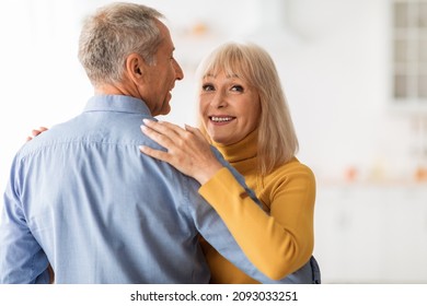 Cheerful Senior Spouses Dancing Slow Dance During Romantic Date Having Fun At Home. Anniversary Celebration, Long- Lasting Marriage And Relationship In Older Age Concept
