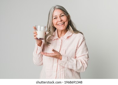 Cheerful Senior Woman Drinking A Glass Of Milk