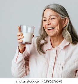 Cheerful Senior Woman Drinking A Glass Of Milk